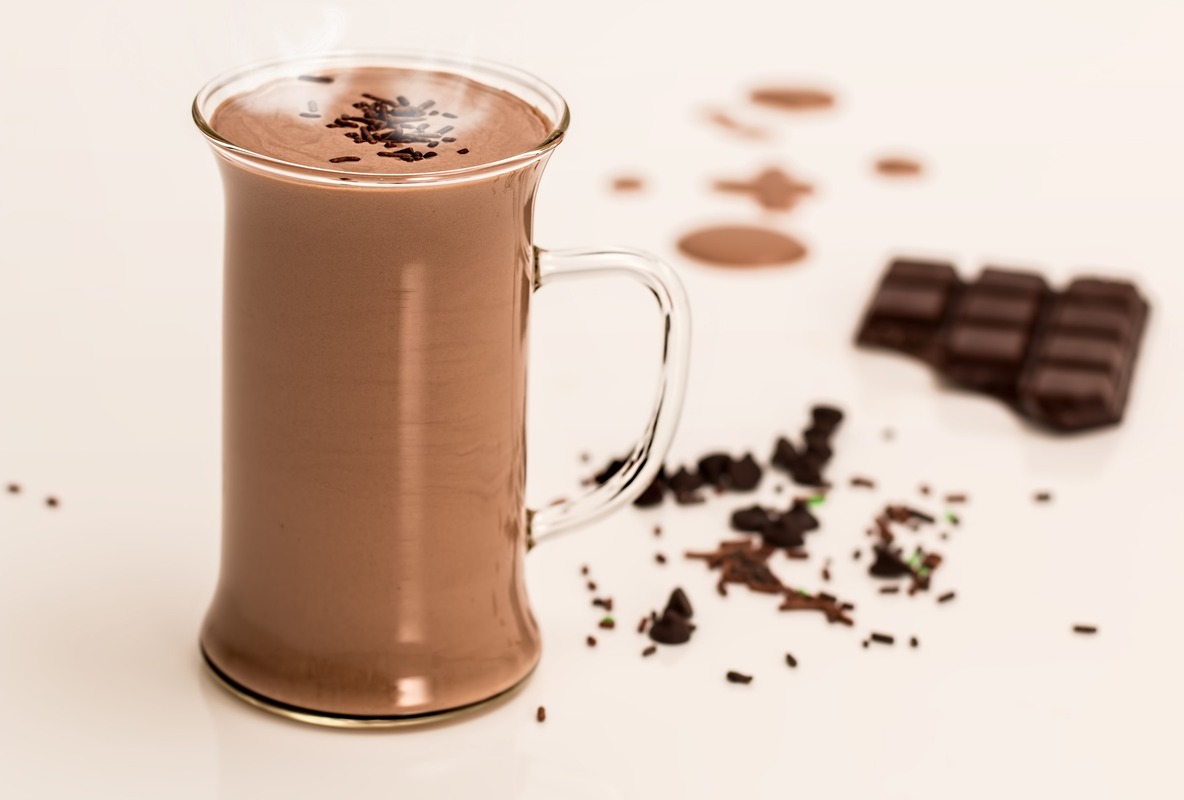 Cup of mushroom hot chocolate with whipped cream and dark chocolate.